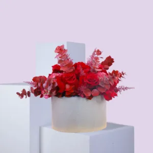 Floral arrangement in a cylindrical container.